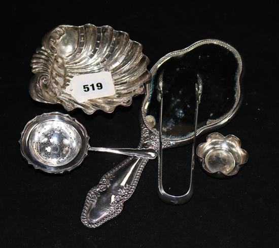 A silver dish, sugar tongs and a mirror and two plated items.